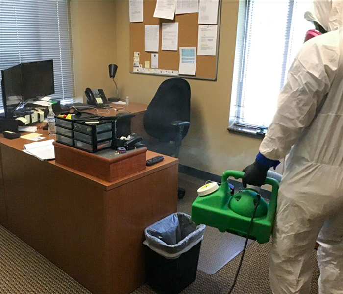 SERVPRO technician fogging and office space