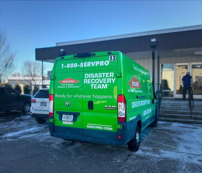 SERVPRO Truck parked in front of a commercial building where water damage from a burst pipe occurred